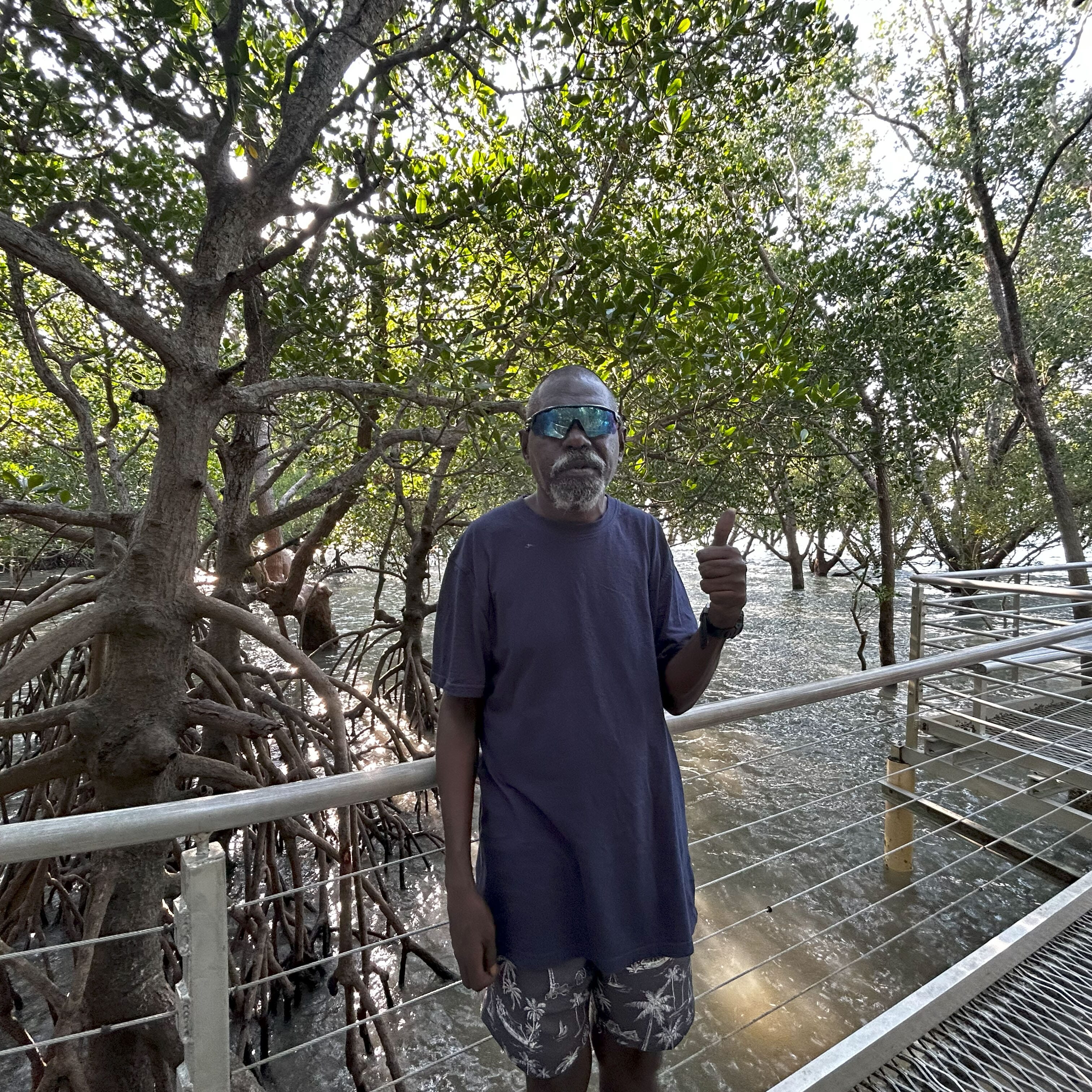 Abel standing on the mangrove boardwalk at East Point Reserve in Darwin, giving a thumbs up.
