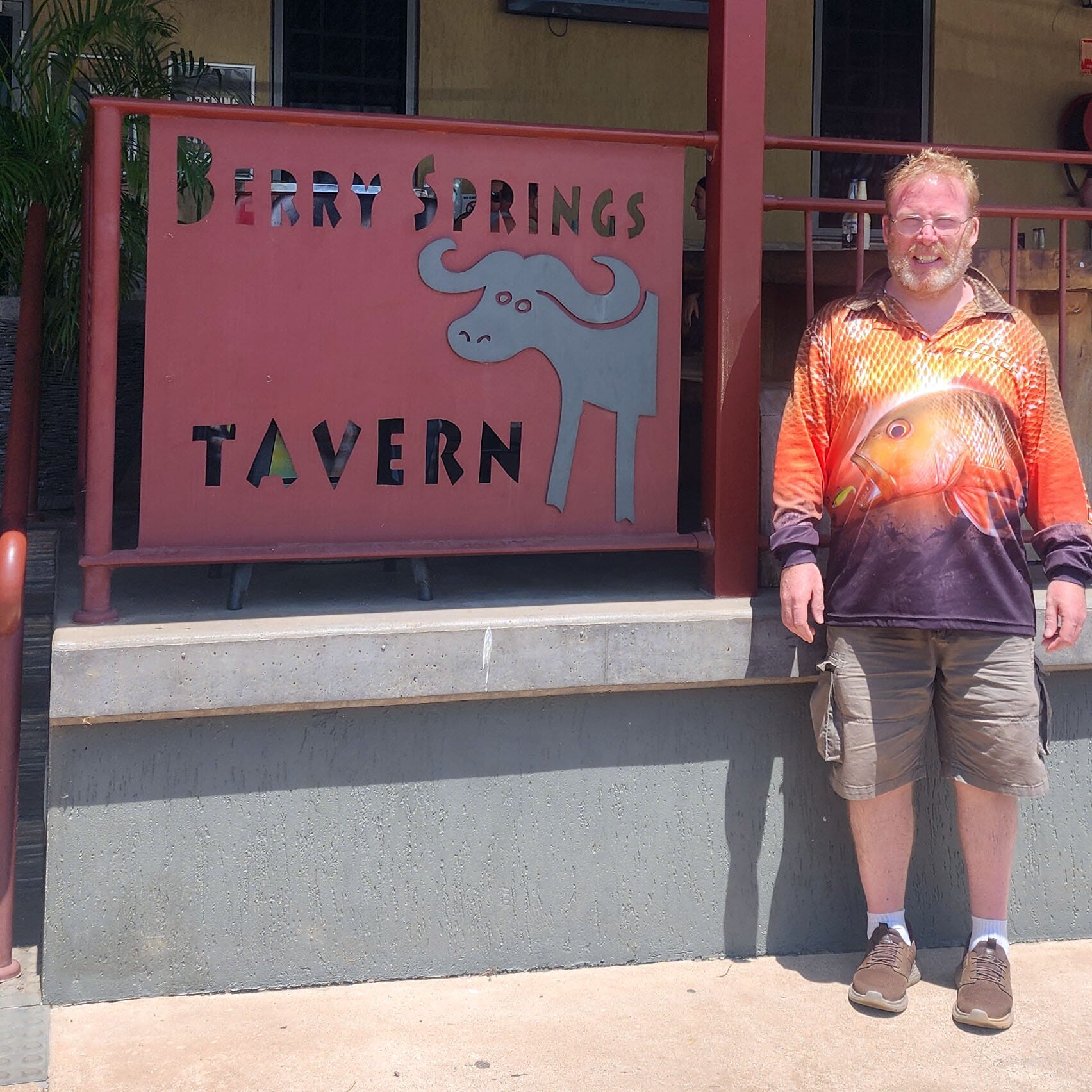 Simon standing outside Berry Springs Tavern in Darwin during a community outing.