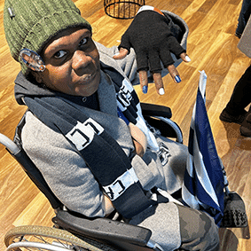 Peatra supporting the Geelong Cats at a live AFL game during community access.